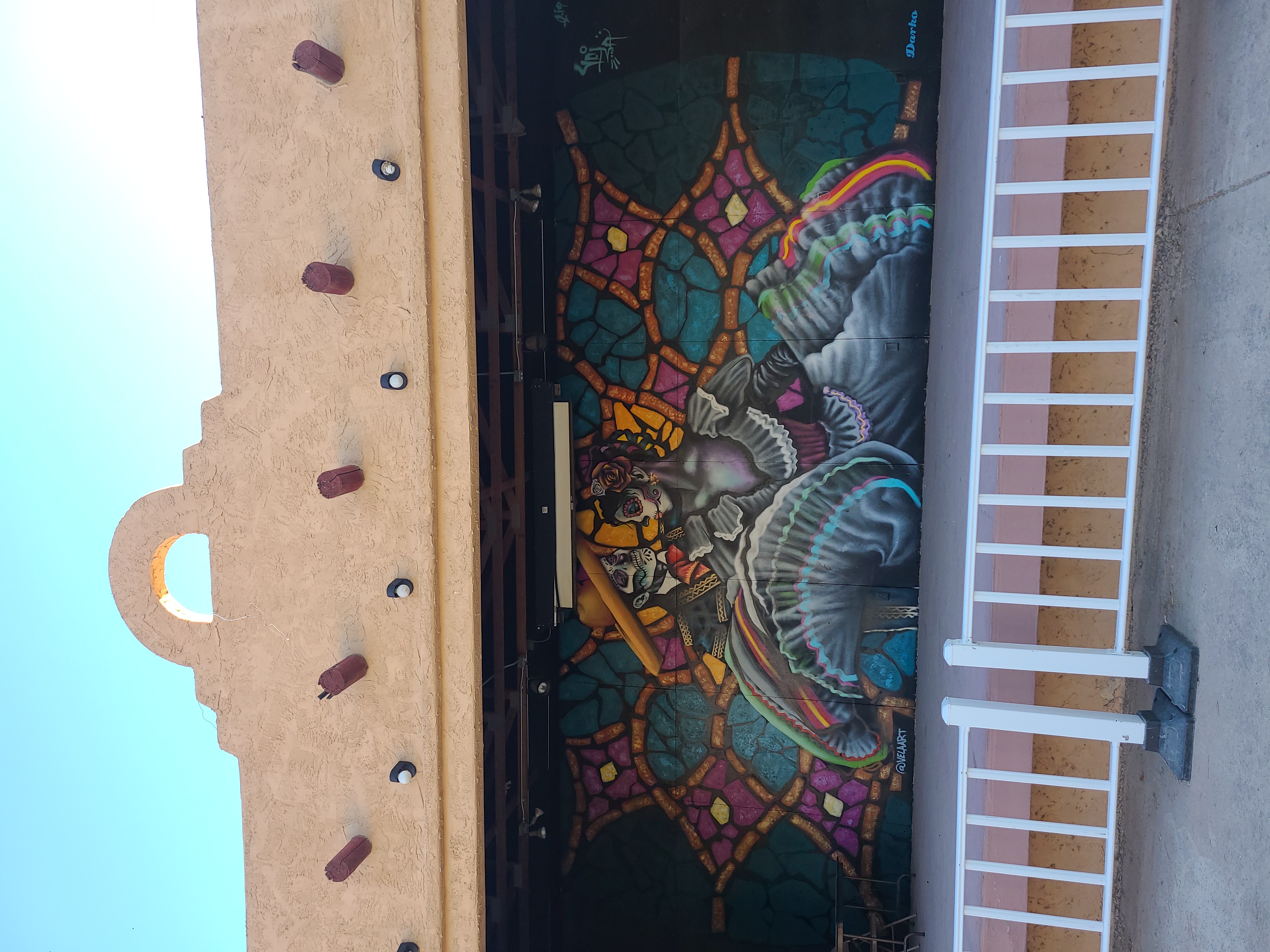 outdoor stage with Southwestern mural